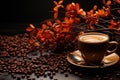 Coffee background with a cup and coffee beans next to some red flowers on a wooden table