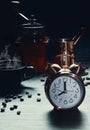 Coffee background of vintage alarm clock at 8 o`clock with a cup of hot coffee, coffee grinder and coffee mug on table with Royalty Free Stock Photo