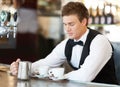 Coffee, barista and young man waiter in cafe making a latte, espresso or cappuccino at an event. Hospitality, server and Royalty Free Stock Photo