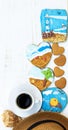 Coffee, beach hat, shell and heart shaped cookies with painted gingerbread of sea, beach, beacon and a girl