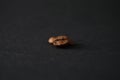 Coffee bean on a black background in the style of minimalism close-up