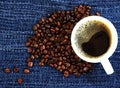 Coffee bean and black hot coffee in cup on wood background Royalty Free Stock Photo