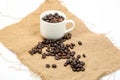 Coffee bean cup on jute fabric Royalty Free Stock Photo