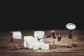 Coffee bean figures are chopping or mining sugar cubes on a wooden table