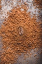 Coffee bean on heap of ground coffee Royalty Free Stock Photo