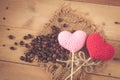 Coffee bean with love heart on wood. Royalty Free Stock Photo