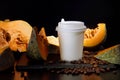 Coffee bean pumpkin spice latte nutrition recipie mock up. cut pumpkin coffee beans and white paper cup for coffee break