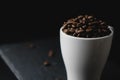 Coffee bean on a white cup over a rock stone slate Royalty Free Stock Photo
