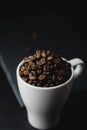 Coffee bean on a white cup over a rock stone slate Royalty Free Stock Photo