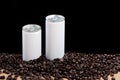 Coffee beans around white cans