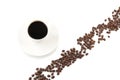 Coffee beans arranged diagonally with coffee cup on white Royalty Free Stock Photo