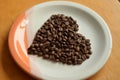 Coffee beans arranged in a heart shape Royalty Free Stock Photo
