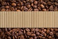 Coffee beans background with brown paper box or Corrugated cardboard for product label Royalty Free Stock Photo