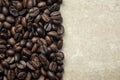 Coffee beans background, empty with copy space for text. Food texture, roasted fragrant appetizing brown arabica beans on a