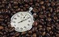 Coffee beans on the background of the stopwatch. Time is running out