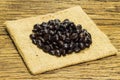 Coffee beans and bag on wooden background