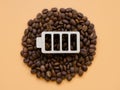 Coffee beans and battery symbol for cheerfulness and energy. Contemporary art concept.