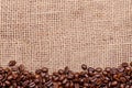 Coffee beans, border on a jute background