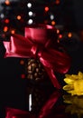 Coffee beans in a bottle as a gift with flower on blury light background