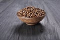 Coffee beans in bowl at wood background Royalty Free Stock Photo