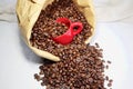 Coffee beans and a ceramic cup in a paper bag on the table Royalty Free Stock Photo