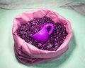 Coffee beans and a purple cup in a paper bag Royalty Free Stock Photo