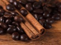 Coffee beans with cinnamon and anise on wooden table Royalty Free Stock Photo