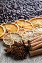 Coffee beans with citrus cinnamon sticks and star anise on the background of burlap Royalty Free Stock Photo