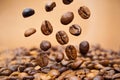 Coffee beans close up falling on pile against brown background