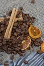 Coffee beans on coarse linen and spices. On a surface of brushed pine boards painted black and white Royalty Free Stock Photo