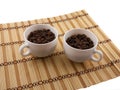 Coffee beans, coffee cup on bamboo background Royalty Free Stock Photo