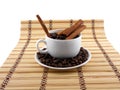 Coffee beans with coffee cup, cinnamon on bamboo background Royalty Free Stock Photo