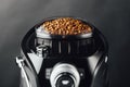 Coffee beans in coffeemaker bean container, close-up view