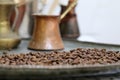 Coffee beans on a copper plate and old turkish coffee pot Royalty Free Stock Photo