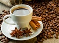 Coffee beans and coffee cup with cinnamon and anise Royalty Free Stock Photo