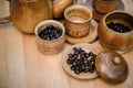 Coffee beans, cup of coffee and teapot on wooden desk. Royalty Free Stock Photo