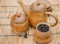 Coffee beans, cup of coffee and teapot on wooden desk. Royalty Free Stock Photo
