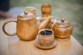 Coffee beans, cup of coffee and teapot on wooden desk. Royalty Free Stock Photo