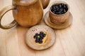 Coffee beans, cup of coffee and teapot on wooden desk. Royalty Free Stock Photo