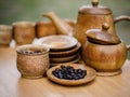 Coffee beans, cup of coffee and teapot on wooden desk. Royalty Free Stock Photo