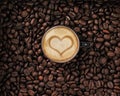 Coffee beans with cup and cream with heart