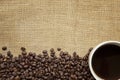 Coffee Beans and Cup over Burlap Royalty Free Stock Photo