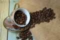 Coffee beans in the cup on the sack. (Still Life Style) Royalty Free Stock Photo