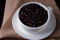 Coffee beans in a coffee cup on a wooden background Royalty Free Stock Photo