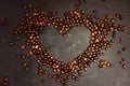 Coffee in beans on dark background. Coffee beans in the form of heart. Coffee beans texture. Royalty Free Stock Photo