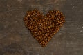 Coffee in beans on dark background. Coffee beans in the form of heart. Abstract background texture.Coffee beans texture. Food Royalty Free Stock Photo