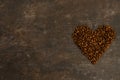 Coffee in beans on dark background. Coffee beans in the form of heart. Abstract background texture.Coffee beans texture. Food Royalty Free Stock Photo