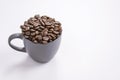 Coffee beans in dark coffee cup on  white background Royalty Free Stock Photo