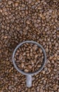 Coffee beans in dark cup on mixed coffee beans background Royalty Free Stock Photo