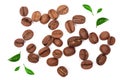 Coffee beans decorated with green leaves isolated on white background. Top view Royalty Free Stock Photo